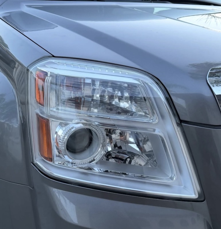 Crystal clear restored headlight on a grey GMC